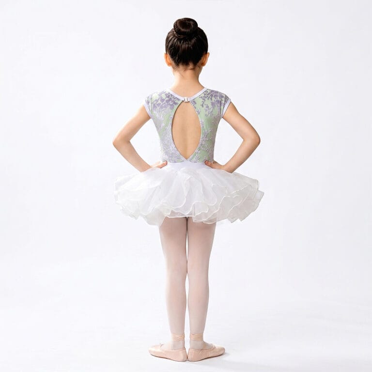 Back view of a child wearing a lace ballet costume with a layered white tutu skirt